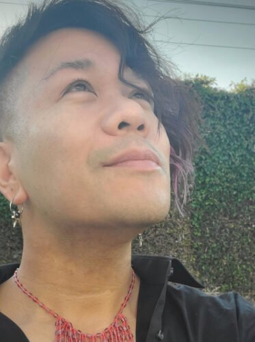 Ren Zen looks upward and smiles